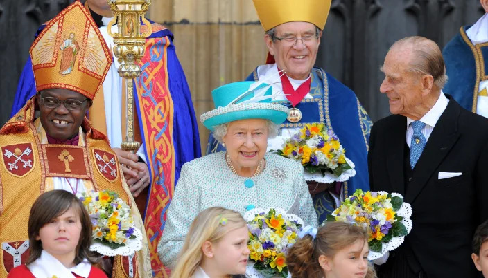 Queen Elizabeth II, then-Archbishop of York John Sentamu, and Prince Philip smiling