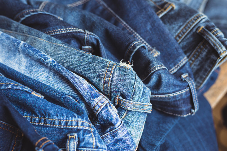 Jeans scattered on a wooden background