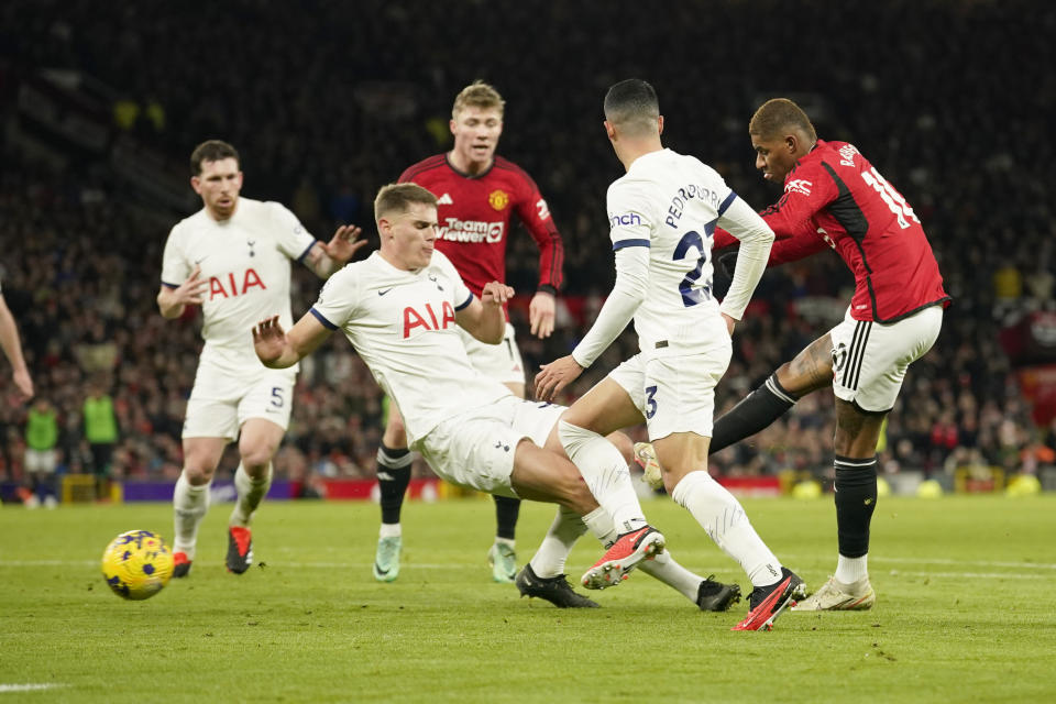 Manchester United's Marcus Rashford, right, scores his side's second goal during the English Premier League soccer match between Manchester United and Tottenham Hotspur at the Old Trafford stadium in Manchester, England, Sunday, Jan.14, 2024. (AP Photo/Dave Thompson)