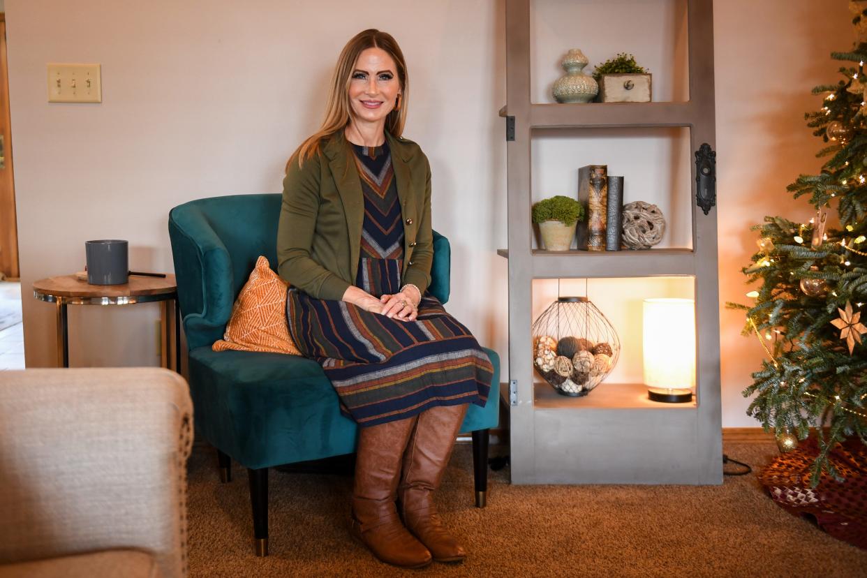 Caminando Juntos educational coordinator April Ross poses inside her living room on Thursday, Dec. 22, 2023 in Sioux Falls.