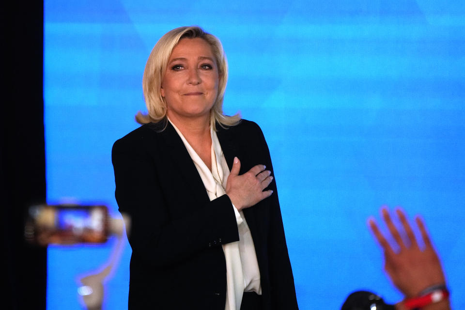 Far-right leader Marine Le Pen gestures as she arrives to speak after the early result projections of the French presidential election runoff were announced in Paris, Sunday, April 24, 2022. French polling agencies are projecting that centrist incumbent Emmanuel Macron will win France's presidential runoff Sunday, beating far-right rival Marine Le Pen in a tight race that was clouded by the Ukraine war and saw a surge in support for extremist ideas. (AP Photo/Francois Mori)