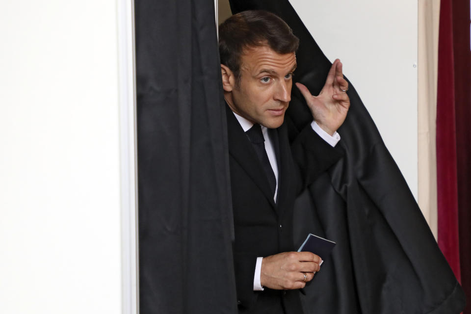 French President Emmanuel Macron exits a voting booth before voting for the European parliamentary elections in Le Touquet, northern France, Sunday May 26, 2019. France is looking at an epic battle between pro-EU centrist President Emmanuel Macron and anti-immigration, far-right flagbearer Marine Le Pen in the European Parliament vote, a duel over Europe's basic values. (Ludovic Marin, Pool via AP)