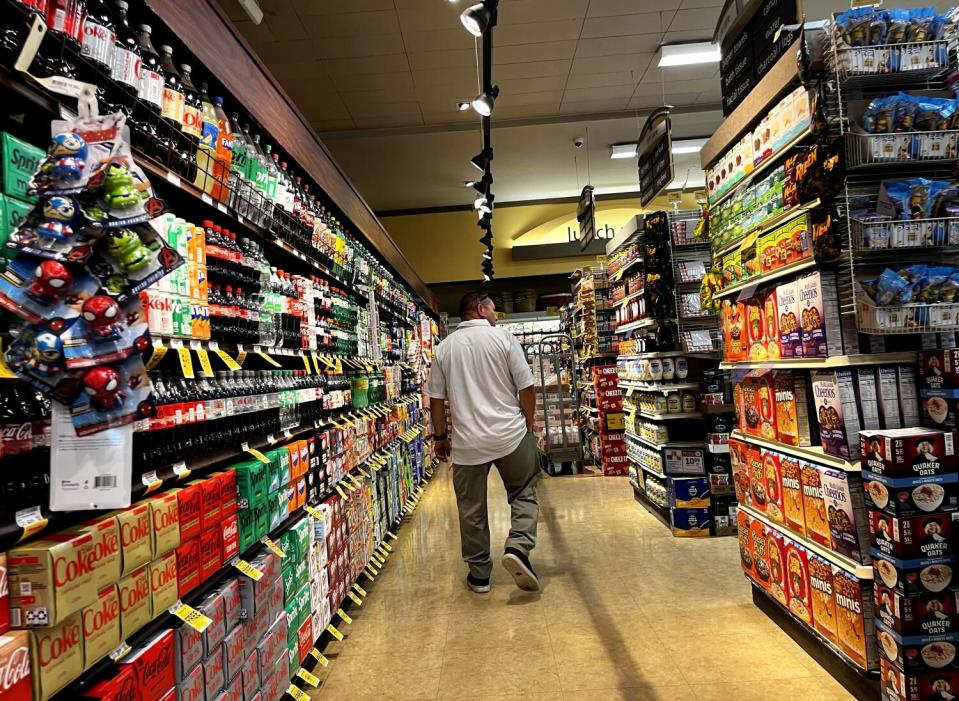 A shopper makes his way down an aisle at Vons in Westchester.