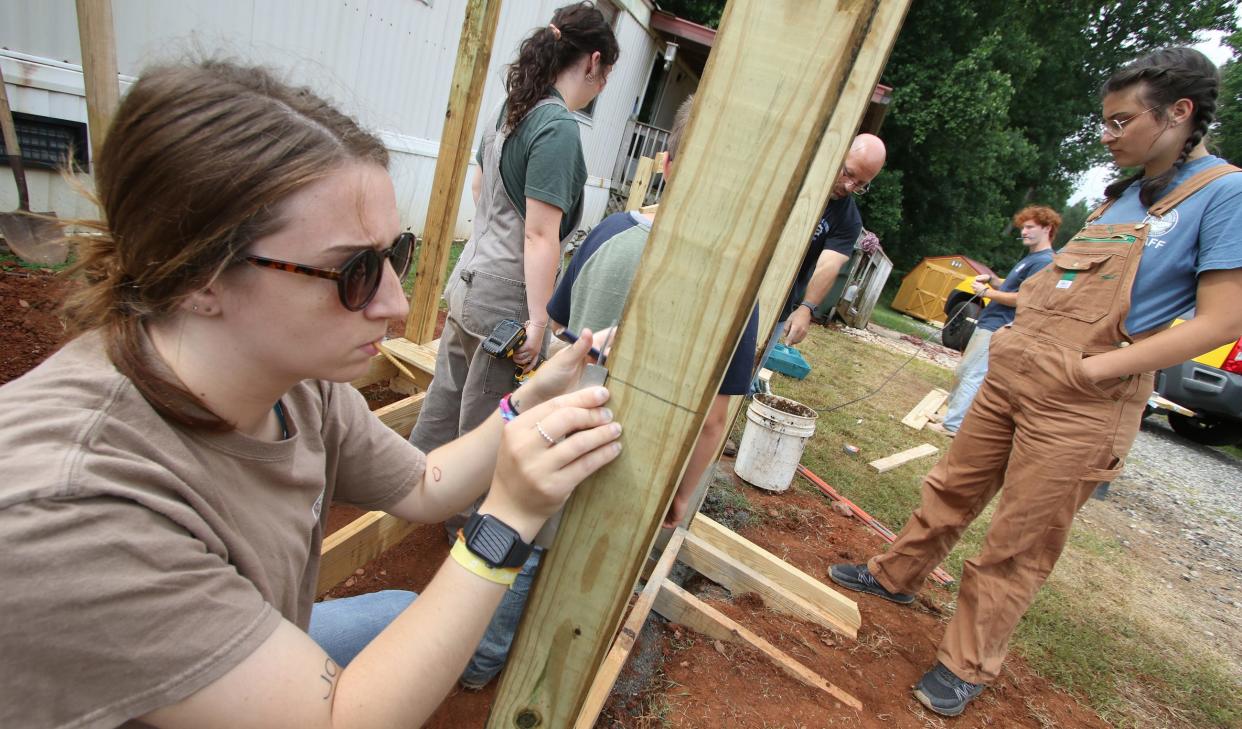 Laura Glomb, left, makes measurements as members of Carolina Cross Connection work to build a ramp outside a home on Fluffy Lane near Bessemer City Friday morning, June 24, 2022.