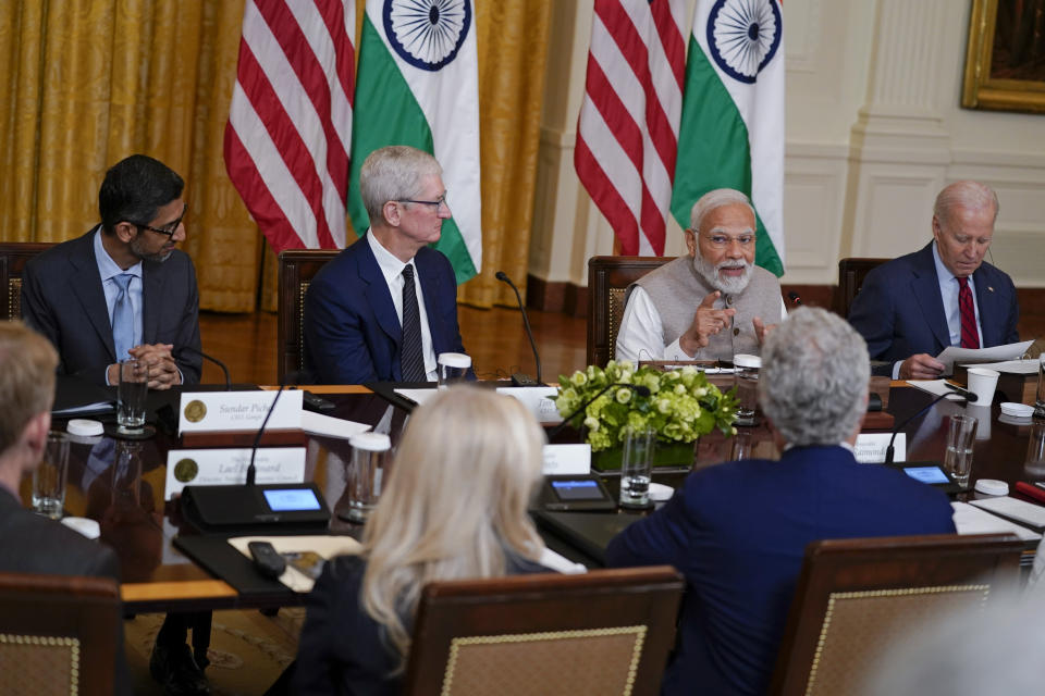 India's Prime Minister Narendra Modi speaks during a meeting with President Joe Biden and American and Indian business leaders in the East Room of the White House, Friday, June 23, 2023, in Washington. From left, Sundar Pichai, CEO of Google, Tim Cook, CEO of Apple, Modi and Biden. (AP Photo/Evan Vucci)