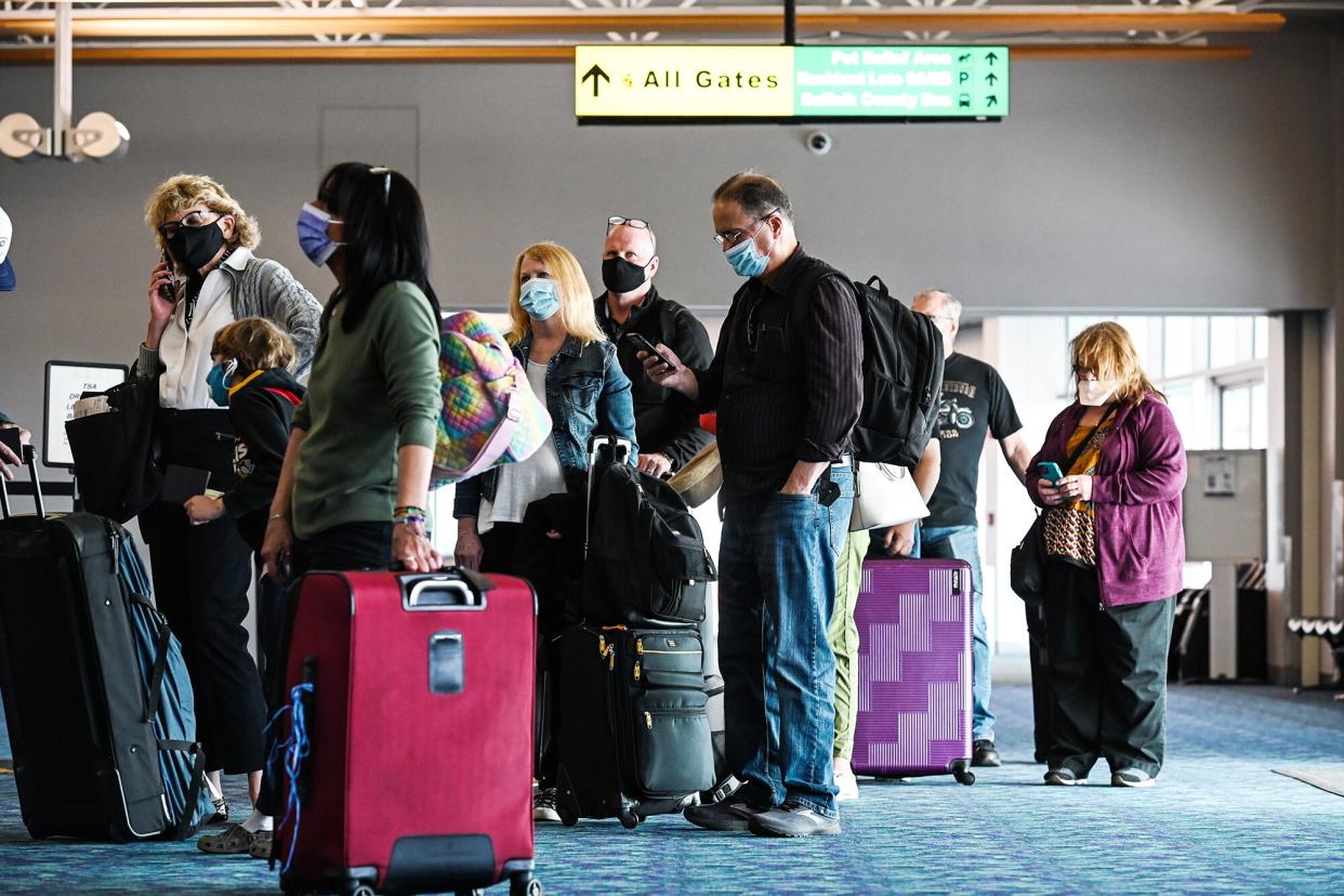 Passengers wait on line in Long Island airport during pandemic