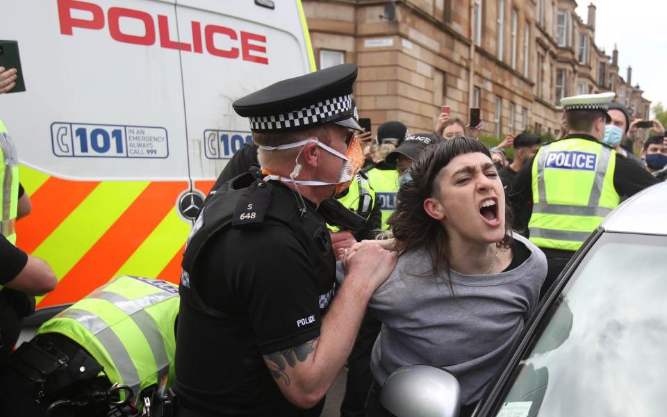 Police and protesters near an immigration van in Kenmure Street, Glasgow - Andrew Milligan/PA
