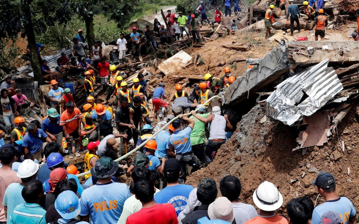 Rescuers search for survivors of a deadly mudslide in Itogon, northern Philippines - REUTERS