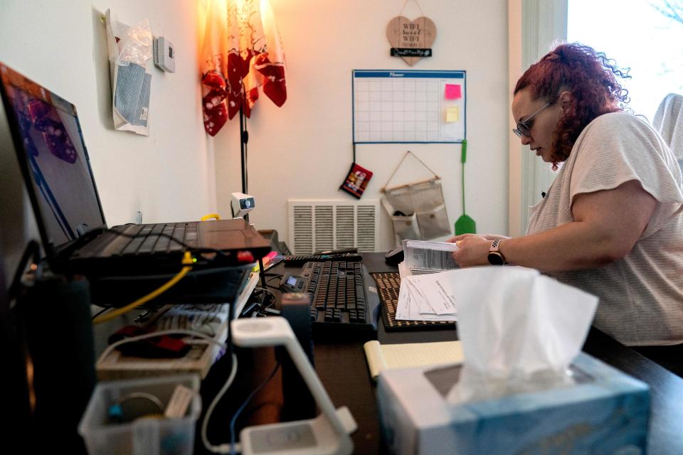 Laine Carolyn goes through paperwork regarding her eviction and medical bills at her home in Alexandria, Virginia, on March 15, 2023. (Photo by Stefani Reynolds / AFP)