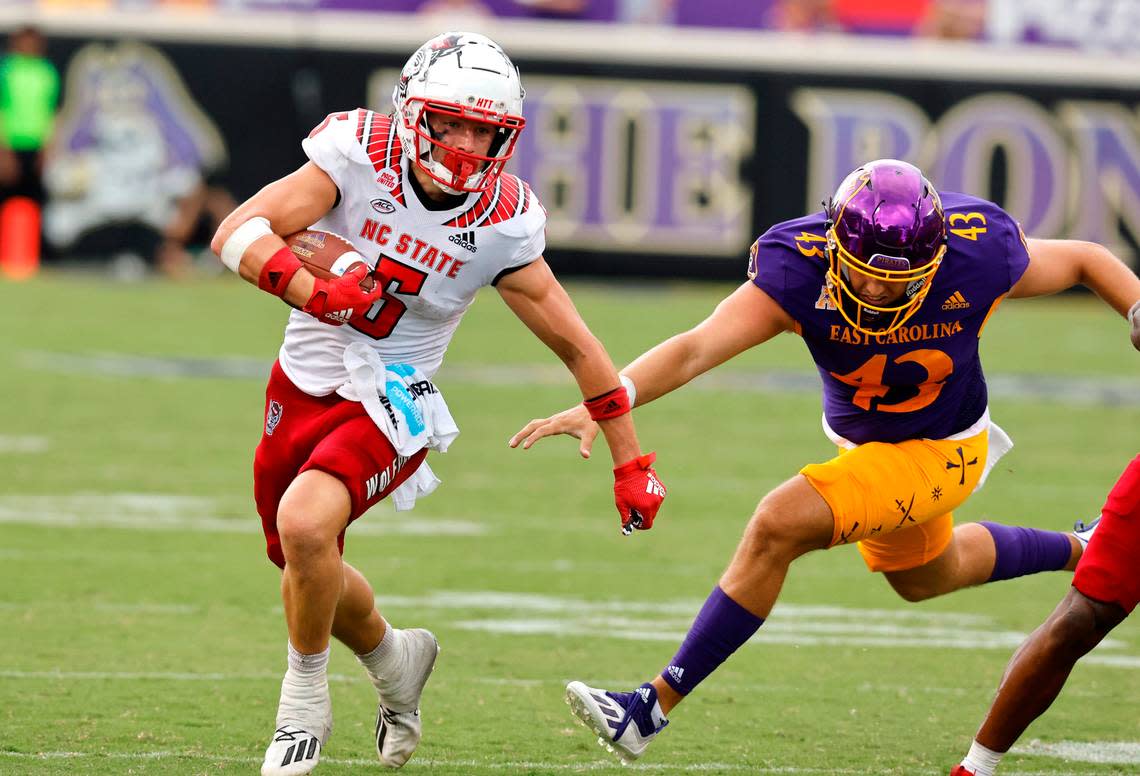 N.C. State wide receiver Thayer Thomas (5) gets by East Carolina long snapper Colby Garfield (43) on a 18-yard punt return during the second half of N.C. State’s 21-20 victory over ECU at Dowdy-Ficklen Stadium in Greenville, N.C., Saturday, Sept. 3, 2022.