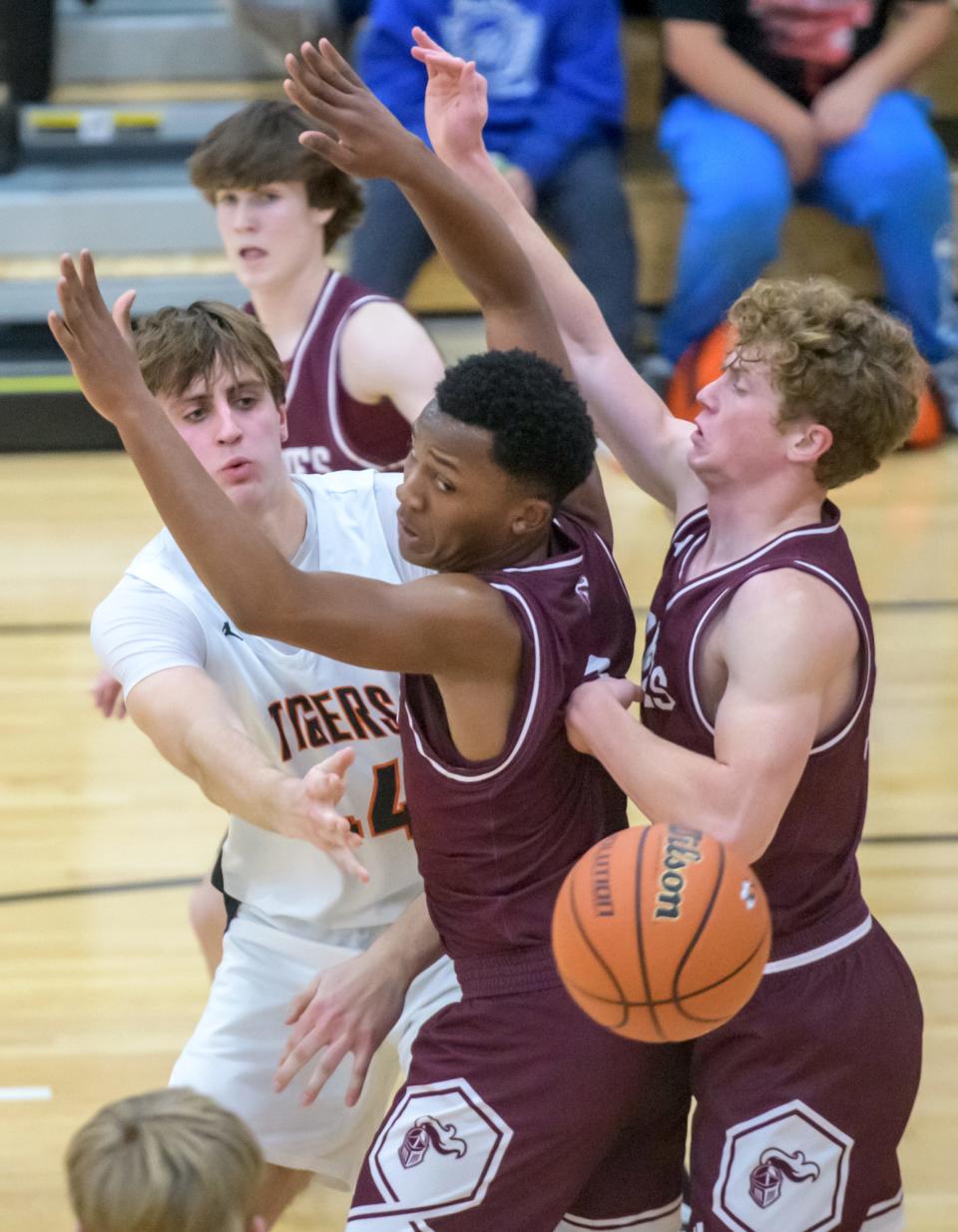 Illini Bluffs' Hank Alvey (44) passes the ball around the Princeville defense in the first half of their nonconference basketball game Friday, Dec. 8, 2023 in Glasford. The Tigers defeated the Princes 51-40.