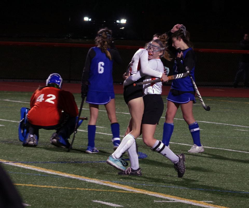 Thursday, Nov. 4, 2021 -- Georgia Costello, who scored the double OT game winning goal for OA, hugs teammate Julia MacLaine in the aftermath, while Scituate players go to console Sailor goalie Beth MacCune (#42).