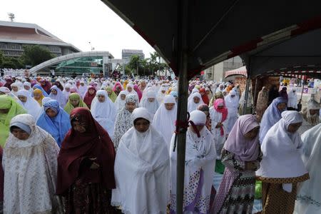 Muslim women attend Eid al-Fitr prayers to mark the end of the holy fasting month of Ramadan in Taipei , Taiwan June 25, 2017. REUTERS/Tyrone Siu