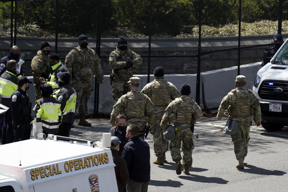 U.S. Capitol Police officers investigate near a car that crashed into a barrier on Capitol Hill near the Senate side of the U.S. Capitol in Washington, Friday, April 2, 2021. (AP Photo/J. Scott Applewhite)