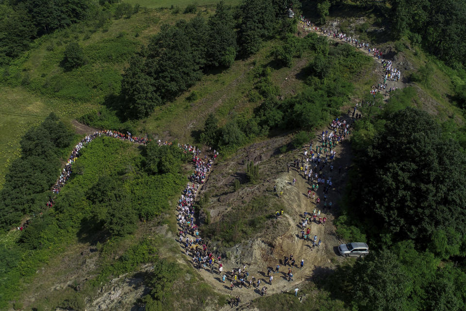 Participants take part in the "March of Peace", march to remember the 1995 Srebrenica massacre, in Nezuk, Bosnia, Saturday, July 8, 2023. A solemn peace march started on Saturday through forests in eastern Bosnia in memory of the 1995 Srebrenica massacre, Europe's only acknowledged genocide since World War II. The 100-kilometre (60-mile) march traces a route taken by Bosniak men and boys as they tried to flee Srebrenica after it was captured by Bosnian Serb forces in the closing days of the country's interethnic war in the 1990s. (AP Photo/Armin Durgut)