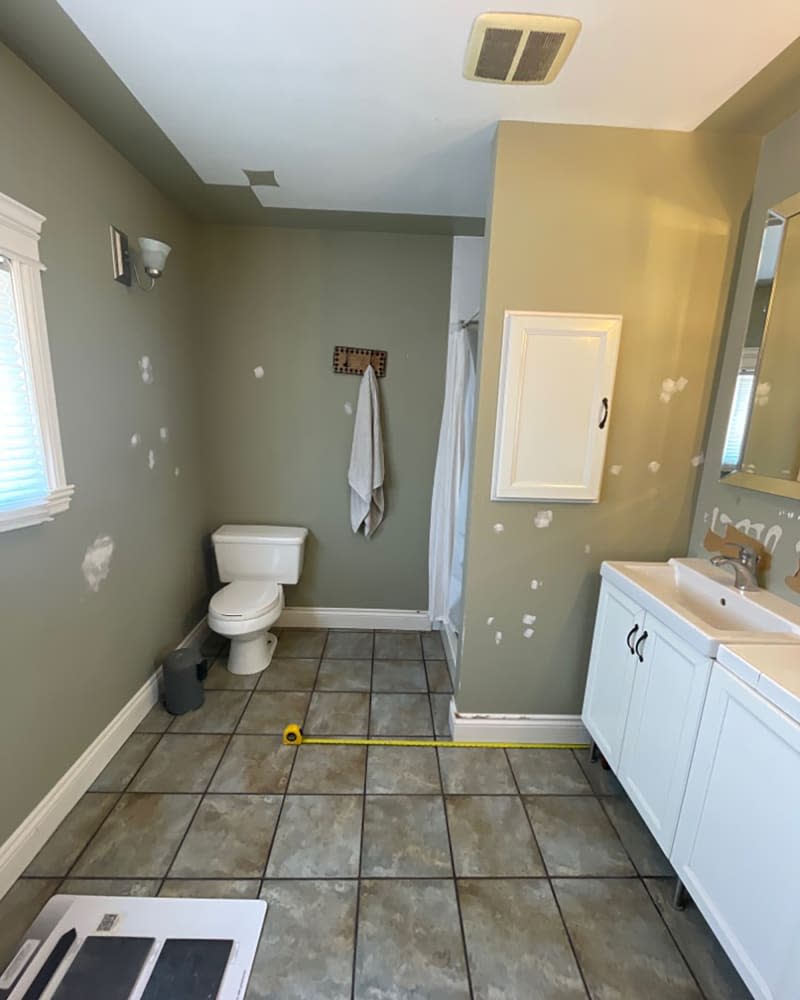 <span>The homeowners also removed the old shower in the corner and created a tiled, glass-doored beauty. Credit: <a href="https://www.instagram.com/natalieapaquin/" rel="nofollow noopener" target="_blank" data-ylk="slk:Natalie Paquin;elm:context_link;itc:0;sec:content-canvas" class="link ">Natalie Paquin</a></span> <span class="copyright">Credit: <a href="https://www.instagram.com/natalieapaquin/" rel="nofollow noopener" target="_blank" data-ylk="slk:Natalie Paquin;elm:context_link;itc:0;sec:content-canvas" class="link ">Natalie Paquin</a></span>