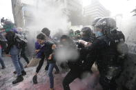 Demonstrators clash with riot police during a march supporting abortion rights in Mexico City, Monday, Sept. 28, 2020. (AP Photo/Marco Ugarte)