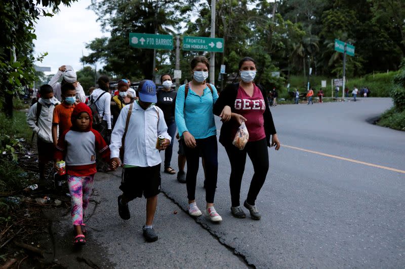 Honduran migrants trying to reach the U.S. walk along a road as they move towards the Mexico border, in Izabal