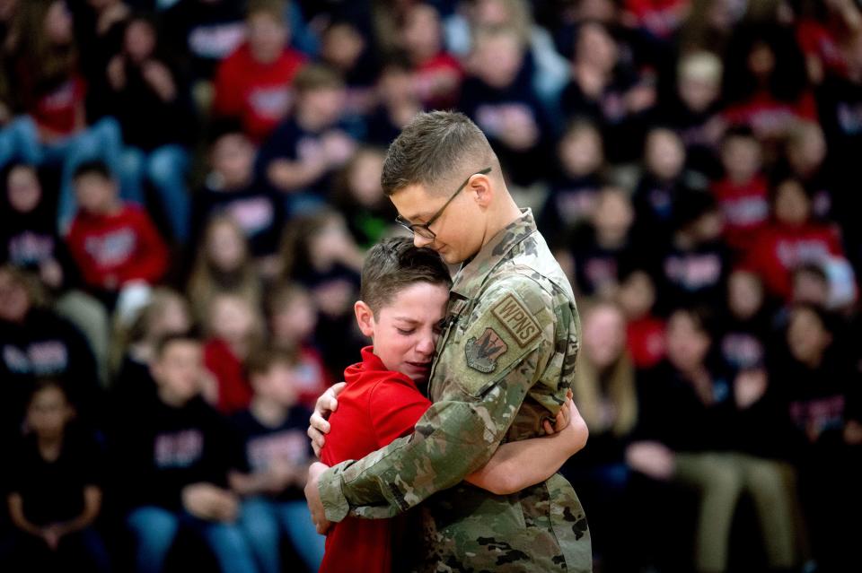 November 22, 2022: Easton Gunsell, 11, cries after rushing into his brother Braden Locker's arms for an embrace after Locker, a 20-year-old airman, surprised him while Gunsell was competing in a free throw competition in St. Robert Catholic School in Flushing, Mich. The Flushing native returned home for Thanksgiving with his family on a short leave from service for the U.S. Air Force while stationed in Saudi Arabia.