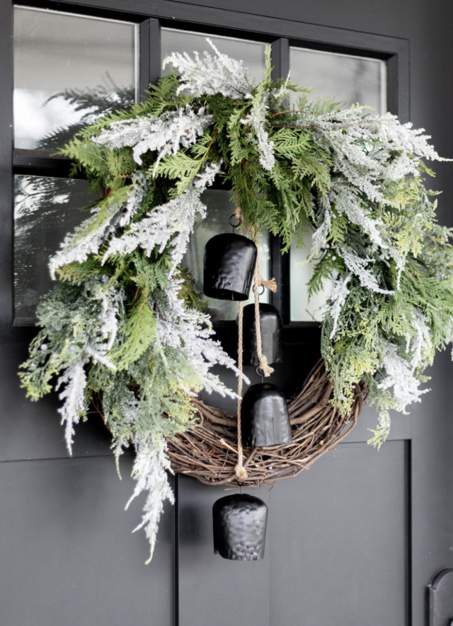 Frosted pine cones sprinkled atop a round evergreen wreath on burlap