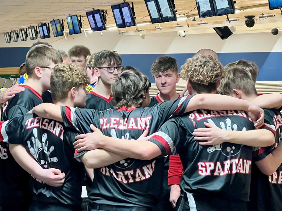 The Pleasant boys bowling team gathers during the Division II state tournament at HP Lanes on Friday.