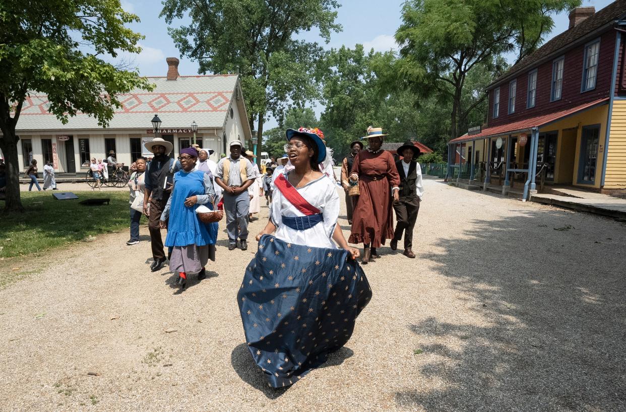 Valerie Boyer, dressed as Lady Liberty, leads the parade processionduring the Juneteenth Jubilee Day Festival on Sunday in the Ohio Village on the grounds of the Ohio History Connection.