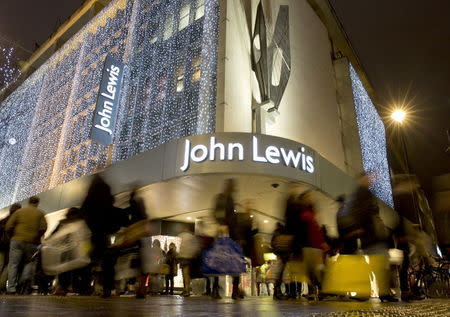 Pedestrians walk past a John Lewis store on Oxford Street in central London, Britain in this December 15, 2013 file photo. REUTERS/Neil Hall