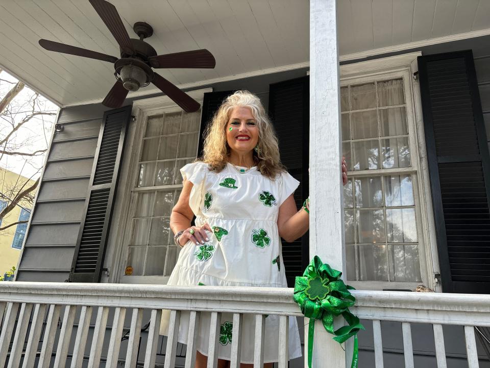 Donna Shepherd, a lifelong Savannah resident, watches the parade from a porch on East Bay Street.