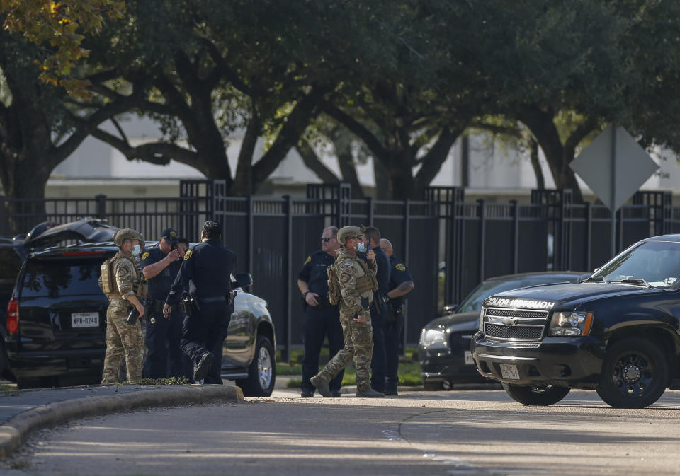 Houston Police officers investigate the scene of an officer-involved shooting at an apartment complex on Tuesday, Oct. 20, 2020, in Houston. Two Houston officers were shot before a SWAT team was dispatched to the scene, where the suspected shooter was arrested, authorities said. (Godofredo A. Vásquez / Houston Chronicle via AP)