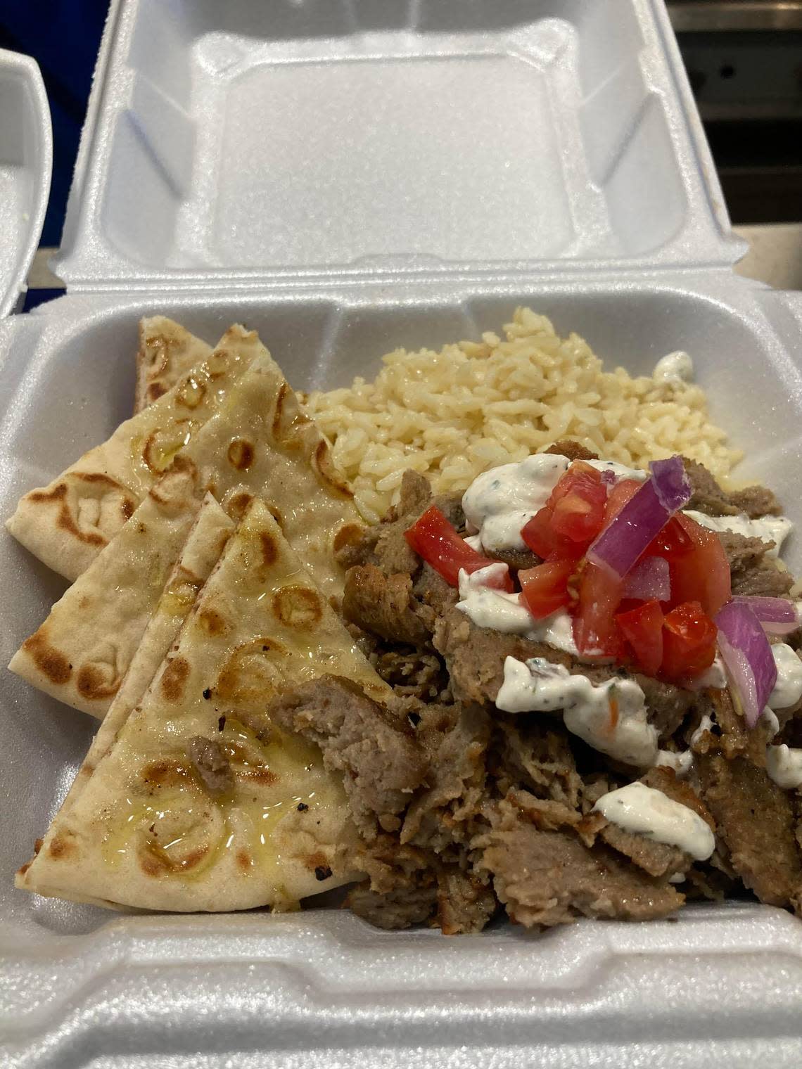 Freshly sliced gyro meat from a spit with tzatziki sauce, rice, pita bread and rice from Olympia Gyros at 670 Lake Joy Road, Suite 150, in Warner Robins