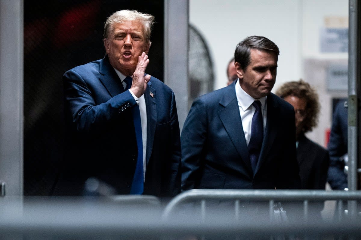 Former president Donald Trump with attorney Todd Blanche as they return from a lunch break in his trial at Manhattan criminal court on Thursday  (AP)