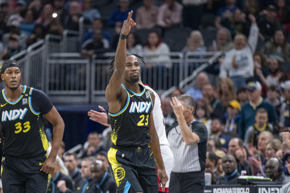 Indiana Pacers forward Aaron Nesmith (23) reacts after scoring a 3-point basket during the first half of an NBA basketball game against the Miami Heat in Indianapolis, Sunday, April 7, 2024. (AP Photo/Doug McSchooler)