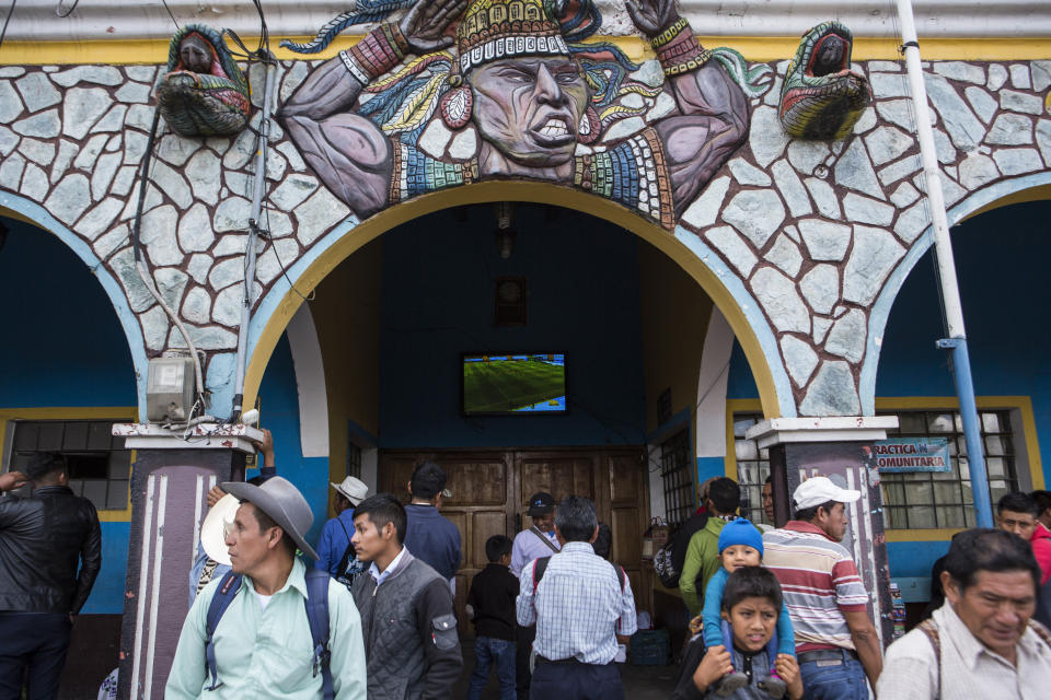Neighbors watch a football match at the central park of San Martin Jilotepeque, Guatemala, Sunday, August 4, 2019. Most people in Guatemalan farming towns like San Martin Jilotepeque have a relative or two living in the United States, giving them sympathy for the plight of migrants. But they now find themselves fearing an influx of Salvadoran or Nicaraguan migrants after their government signed a "third safe country" agreement with Washington. (AP Photo/ Oliver de Ros)