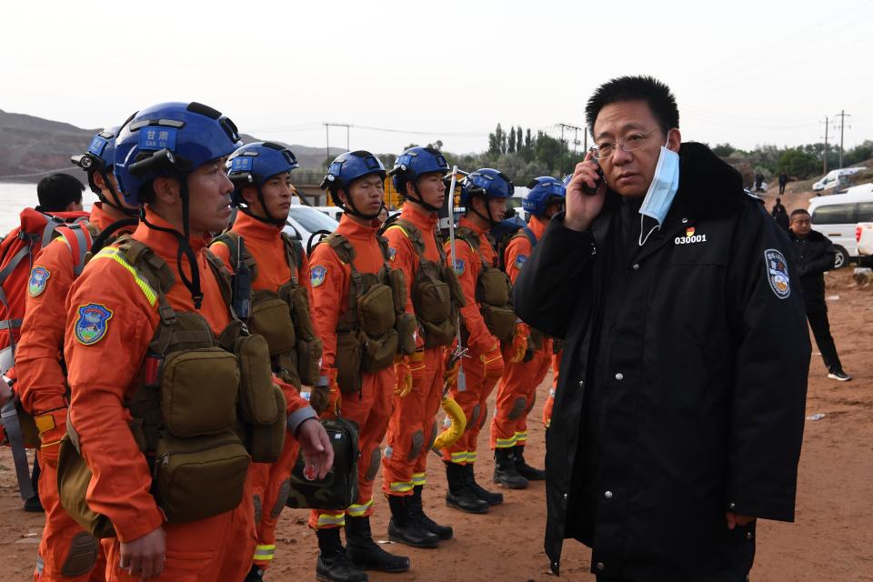 Rescuers discuss the details to search for survivors in Jingtai County of Baiyin City, northwest China's Gansu Province, after sudden extreme weather during a mountain race. (Fan Peishen/Xinhua via Getty Images)