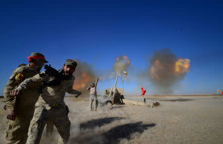 Shi'ite fighters fire artillery towards Islamic State militants during a battle with Islamic State militants on the outskirt of Tal Afar west of Mosul, Iraq, November 18, 2016. REUTERS/Stringer