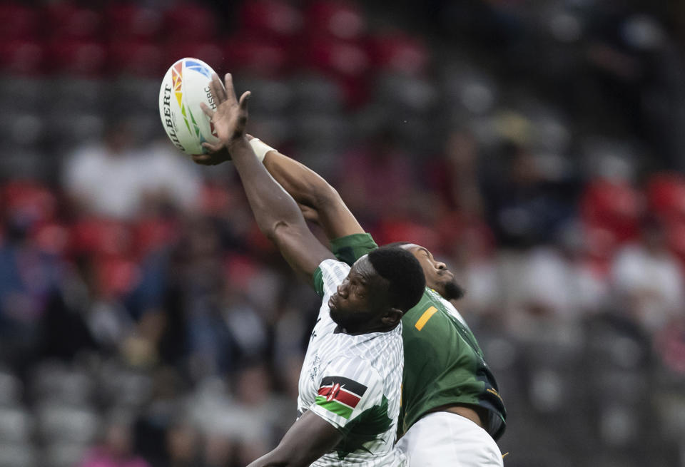 Kenya's Levy Amunga, left, and South Africa's Darren Adonis vie for the ball during an HSBC Canada Sevens rugby game in Vancouver, British Columbia, Saturday, Sept. 18, 2021. (Darryl Dyck/The Canadian Press via AP)