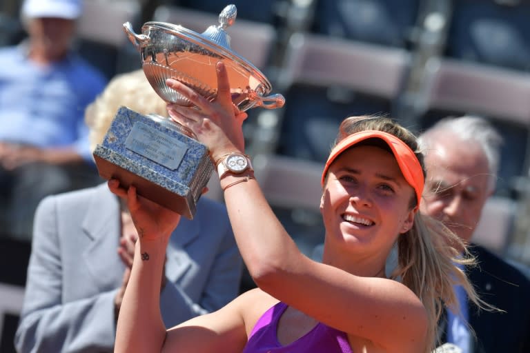 Elina Svitolina of Ukraine poses with the trophy after beating Simona Halep of Romania, on May 21, 2017