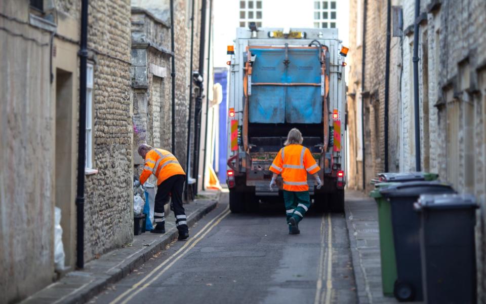 Garbage men collect household rubbish and recycling in Cirencester, the capital of the Cotswolds