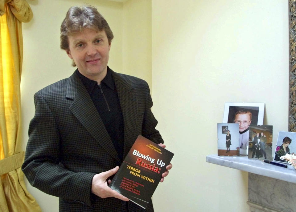 FILE – Russian defector Alexander Litvinenko, a former operative for the KGB and FSB, is seen at his home in London, on Friday, May 10, 2002. Litvinenko was viewed as a traitor by the Kremlin after fleeing to Britain in 2000. He died after drinking tea laced with radioactive polonium-210 at a hotel in London. On his deathbed, Litvinenko claimed that Russian President Vladimir Putin directly ordered his assassination. A British inquiry later found that Russian agents had killed Litvinenko, probably with Putin's approval. (AP Photo/Alistair Fuller, File)