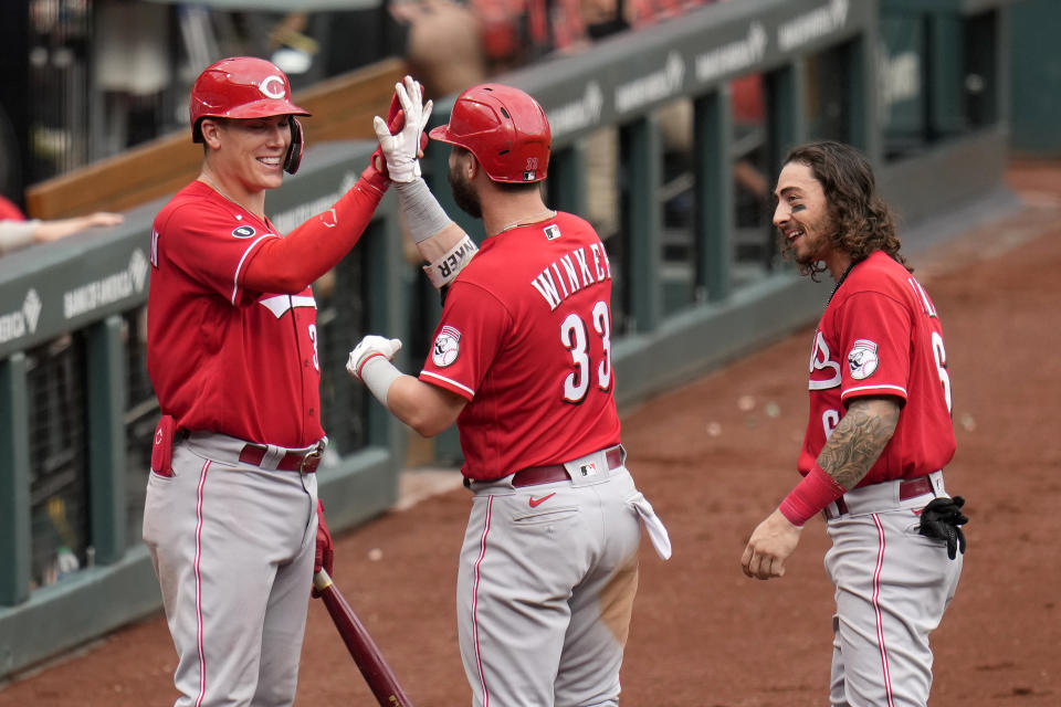 Cincinnati Reds' Jesse Winker (33) is congratulated by teammates Jonathan India, right, and Tyler Stephenson, left, after hitting his third home run of a baseball game during the ninth against the St. Louis Cardinals Sunday, June 6, 2021, in St. Louis. (AP Photo/Jeff Roberson)