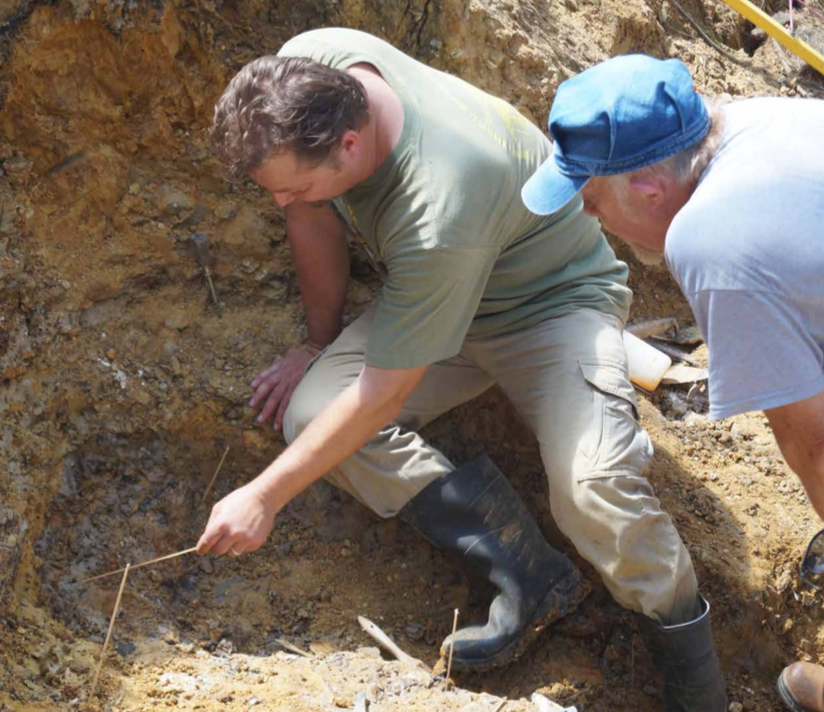 Peter Makovicky, at left, and Guy Darrough, examining the clay that may contain more bones of the Missouri dinosaur.