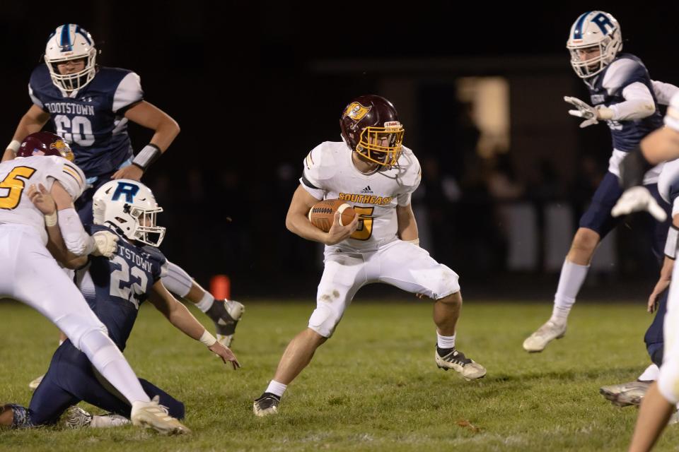 Southeast senior quarterback Randy Williams runs with the ball during Friday night's game against the Rootstown Rovers in Rootstown.