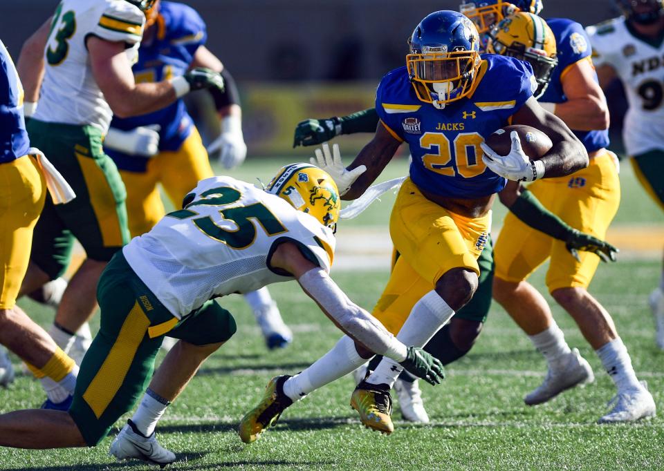 South Dakota State's Pierre Strong, Jr. avoids a tackle by North Dakota State's Michael Tutsie in the annual Dakota Marker game on Saturday, November 6, 2021 at Dana J. Dykhouse Stadium in Brookings.