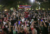 Pro-democracy protesters wave the national flag at the Sanam Luang field during a protest in Bangkok, Thailand, Saturday, Sept. 19, 2020. Thousands of demonstrators turned out Saturday for a rally to support the student-led protest movement's demands for new elections and reform of the monarchy. (AP Photo/Wason Wanichakorn)