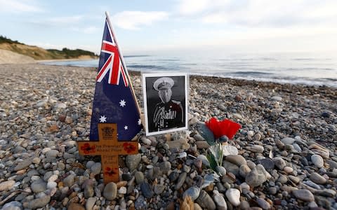 A cross and a picture of an Australian soldier who fought at Gallipoli at Anzac Cove in the Gallipoli peninsula in 2016. - Credit: REUTERS/Murad Sezer