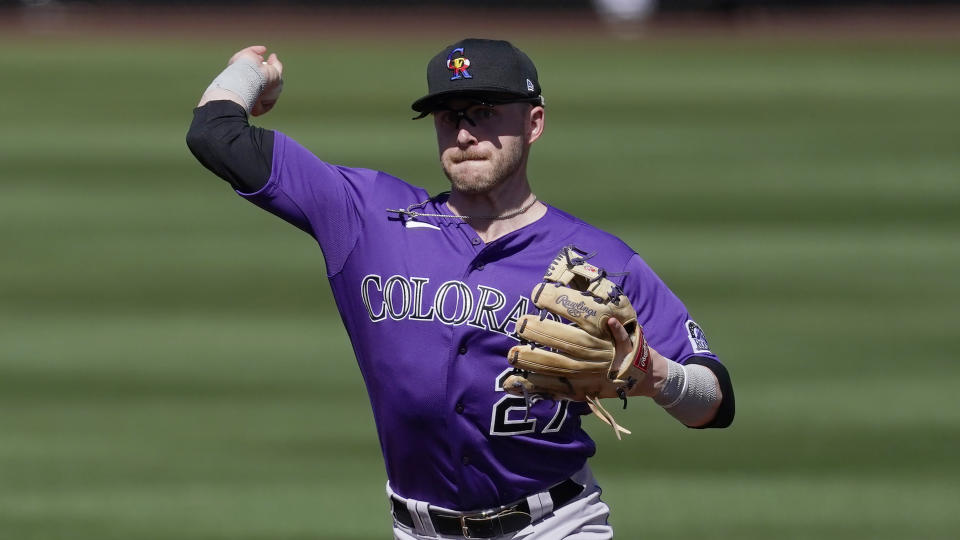 Colorado Rockies shortstop Trevor Story (27) throws to first during a spring training baseball game against the Arizona Diamondbacks Tuesday, March 9, 2021, in Scottsdale, Ariz. (AP Photo/Ashley Landis)