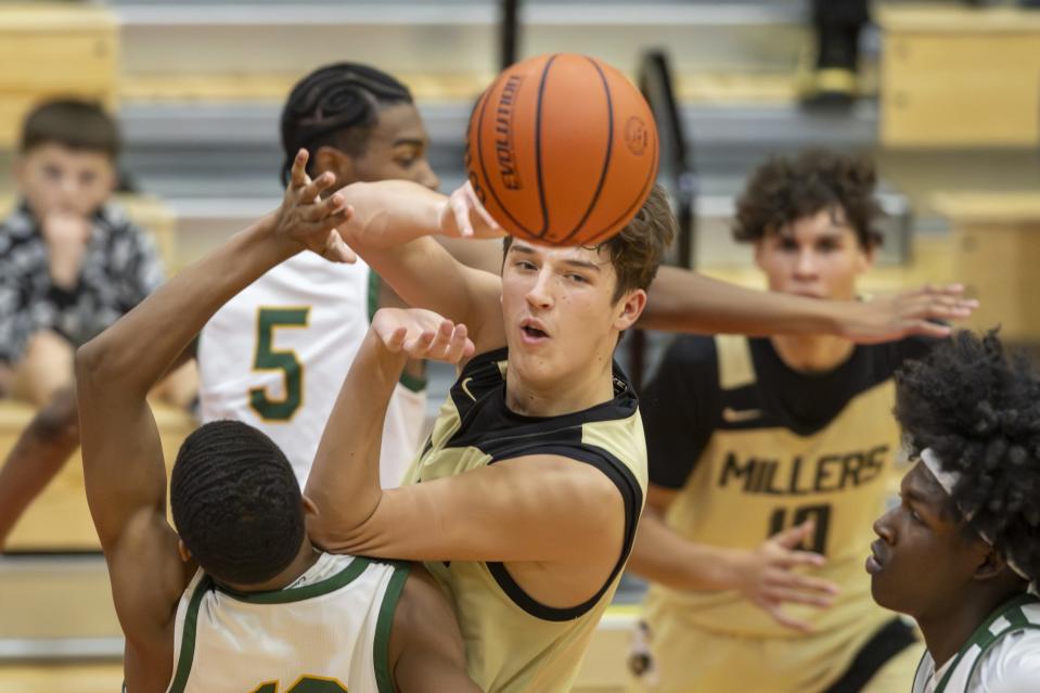 Noblesville High School senior Hunter Walston (24) passes the ball off to a teammate during the second half of an IHSAA basketball game against Indianapolis Crispus Attucks High School, Saturday, Dec. 9, 2023, at Southport High School.