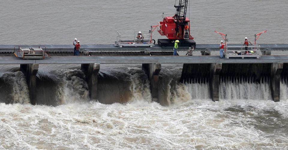 Workers open bays of the Bonnet Carré Spillway to divert rising water from the Mississippi River to Lake Pontchartrain, upriver from New Orleans, in Norco, La., May 10, 2019.