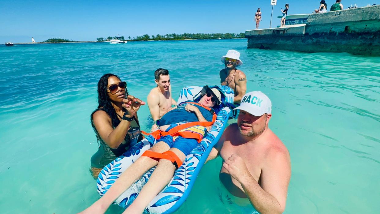 Patient Arnie Grinblatt with D-MAN (Danny’s Miracle Angel Network) board member Bryan Barnett, Calvin Kassab (brother of founder Ziad Kassab and the late Danny Kassab), therapist Alex Gammiccia and an unnamed caregiver on the beach last February in Nassau, Bahamas.