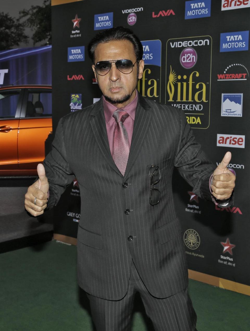 Indian film star Gulshan Grover poses for photographers as he walks the green carpet for 15th annual International Indian Film Awards Saturday, April 26, 2014, in Tampa, Fla. (AP Photo/Chris O'Meara)